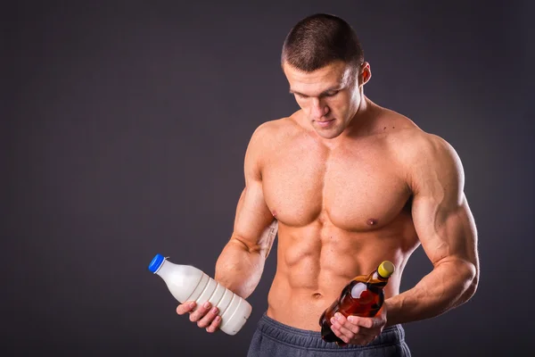 Man holding a beer and milk — Stock Photo, Image