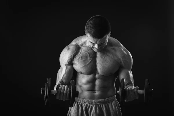 Homem faz exercícios com halteres — Fotografia de Stock