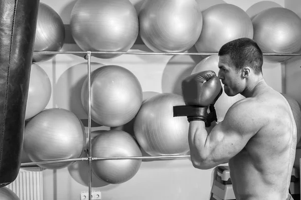 L'homme a frappé un sac de boxe dans la salle de gym — Photo