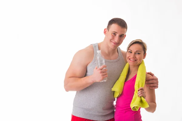 Couple in sportswear with bottle of water — Stock Photo, Image