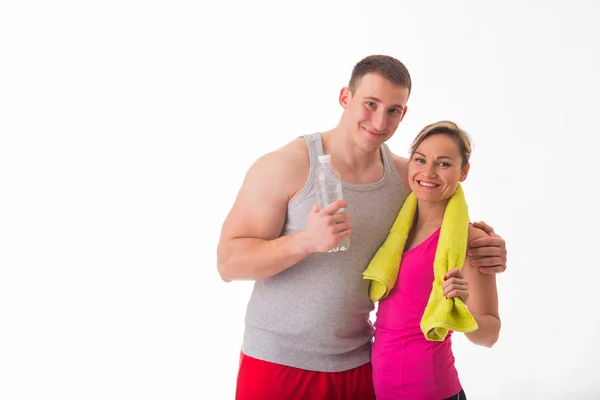Couple in sportswear with bottle of water — Stock Photo, Image