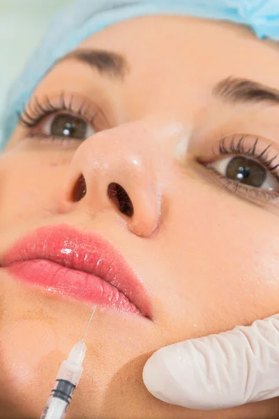 Beautician makes injection into the patient's face — Stock Photo, Image