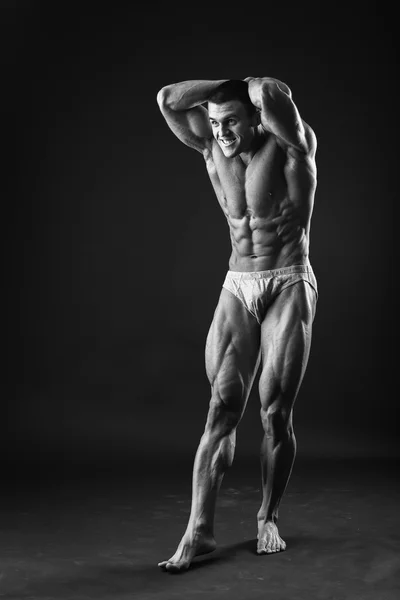 Muscular bodybuilder shows his muscles. — Stock Photo, Image