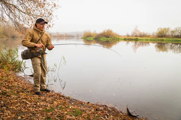 Fisherman with spinning — Stock Photo, Image