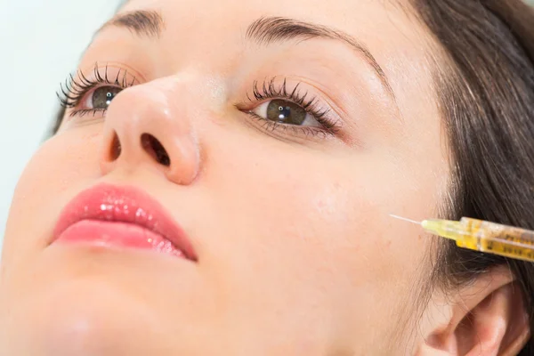 Beautician makes injection into the patient's face — Stock Photo, Image