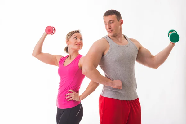 Athletic couple holding dumbbells — Stock Photo, Image