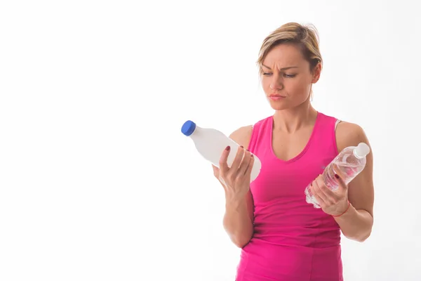 Girl holding bottle of water and milk — Stock Photo, Image