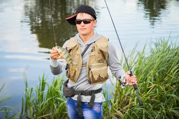 Pescador sosteniendo una percha en la mano — Foto de Stock