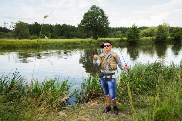 Fisherman holding a perch in hand — Stock Photo, Image