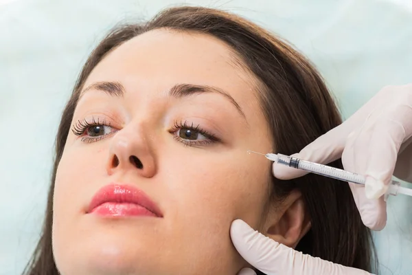 Beautician makes injection into the patient's face — Stock Photo, Image