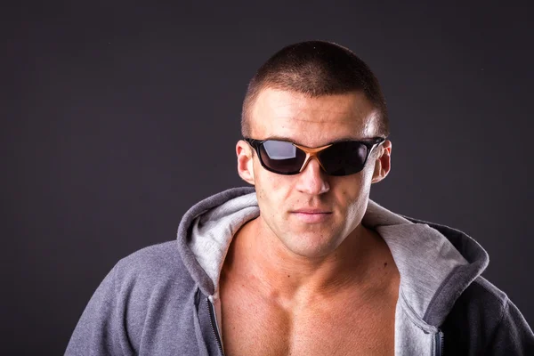 Man in a sports jacket and sunglasses — Stock Photo, Image