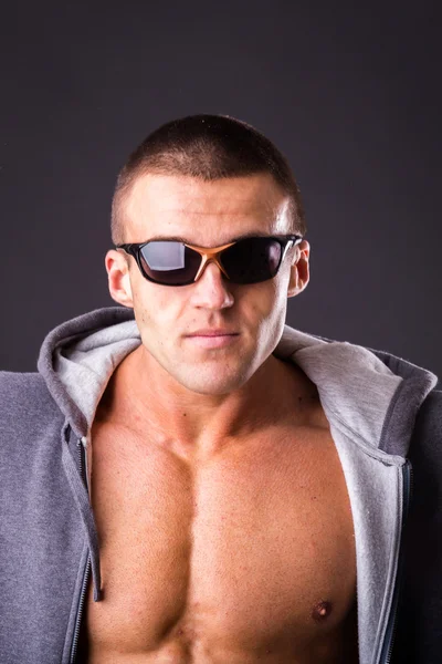 Man in a sports jacket and sunglasses — Stock Photo, Image