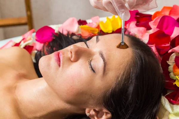 Woman receiving facial massage