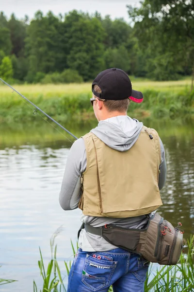 Fisherman on the river bank — Stock Photo, Image