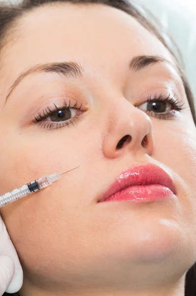 Beautician makes injection into the patient's face — Stock Photo, Image