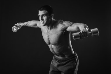 adam dumbbells ile çalışmaları yapan