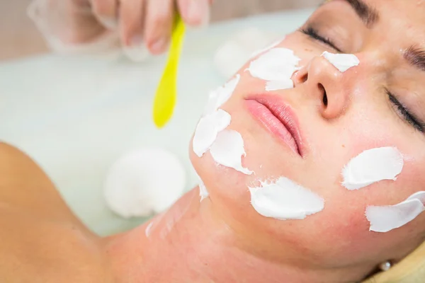 Jeune femme recevant un masque facial — Photo