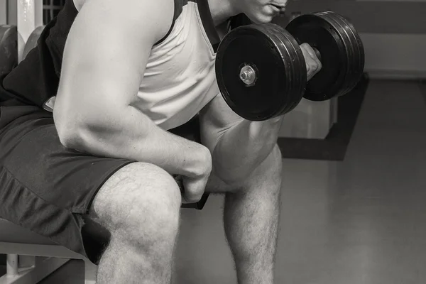 Man makes exercises with dumbbells — Stock Photo, Image