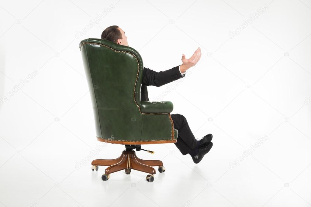 Male businessman sitting on leather chair