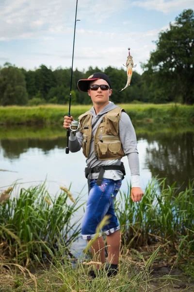 Fisherman on the river bank — Stock Photo, Image