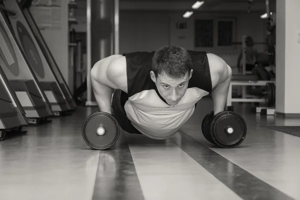 Man doing push up exercise with dumbbells — Stock Photo, Image