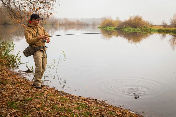 Fisherman with spinning — Stock Photo, Image