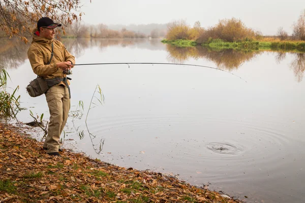 Fisherman with spinning — Stock Photo, Image