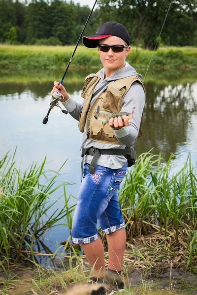 Fisherman on the river bank — Stock Photo, Image