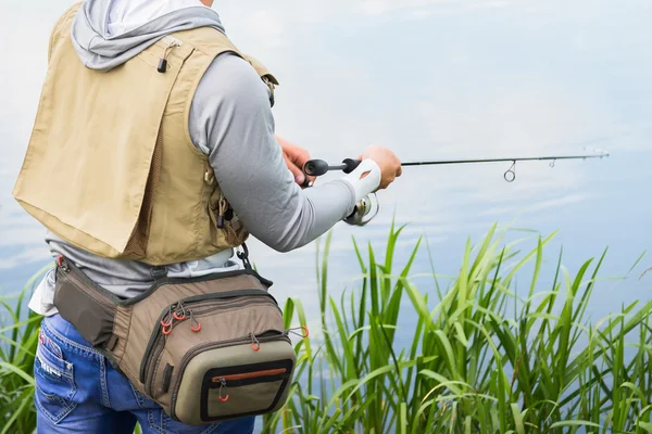 Fisherman on the river bank — Stock Photo, Image