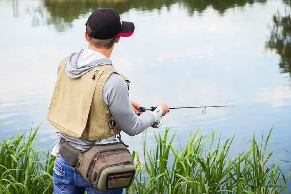 Fisherman on the river bank — Stock Photo, Image