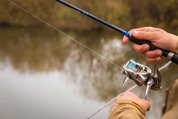 Fisherman with spinning — Stock Photo, Image