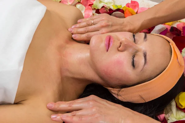 Woman receiving facial massage