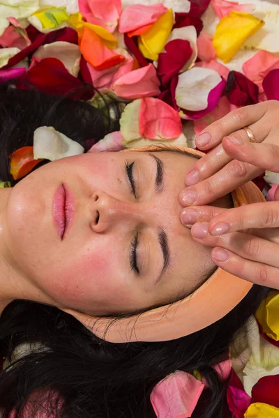 Woman receiving facial massage