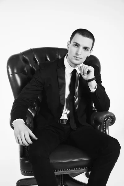 Male businessman sitting on leather chair — Stock Photo, Image