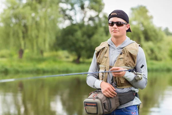 Fisherman with spinning — Stock Photo, Image