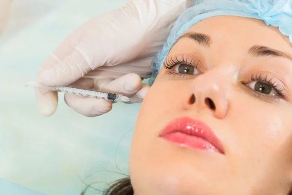 Beautician makes injection into the patient's face — Stock Photo, Image