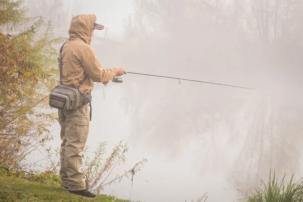 Fisherman standing with spinning — Stock Photo, Image