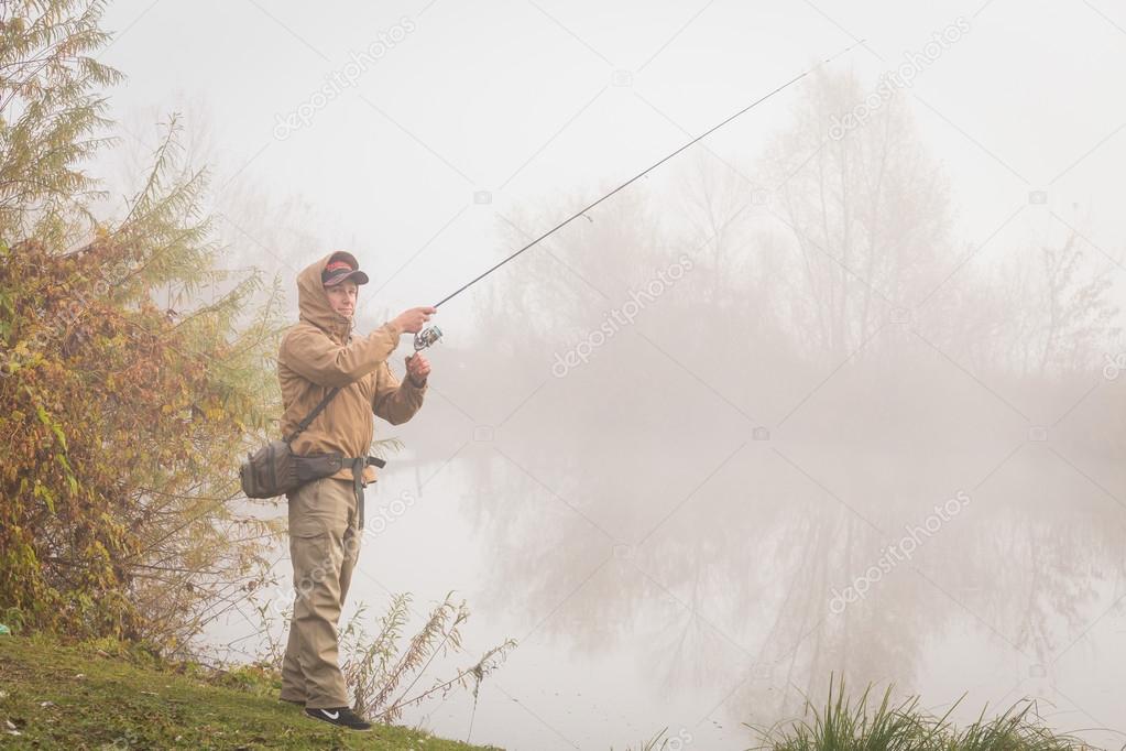 Fisherman standing with spinning