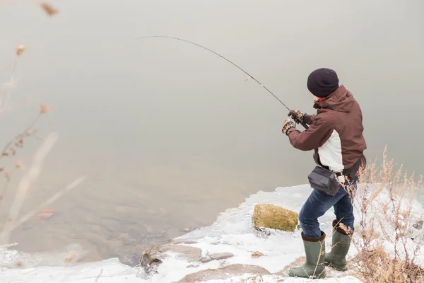 Fisherman with spinning on the winter — Stock Photo, Image