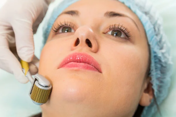 Beautician performs anti-aging treatment