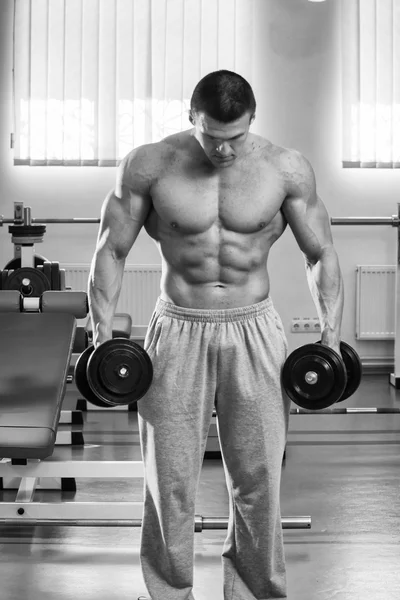 Strong man in the GYM — Stock Photo, Image