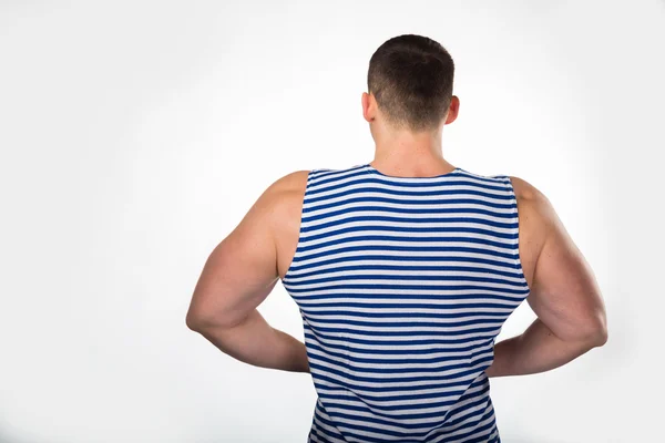 Uomo muscolare in un gilet a righe — Foto Stock