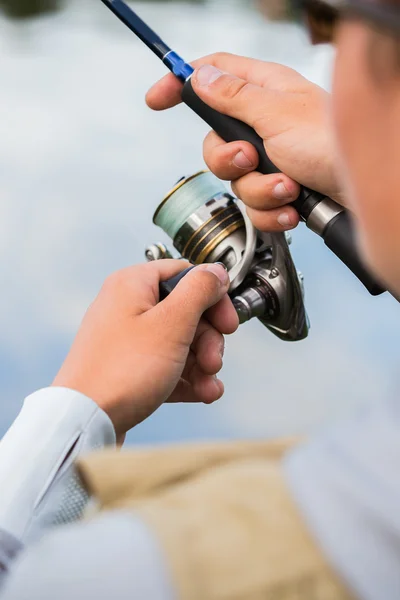 Fisherman with spinning closeup — Stock Photo, Image