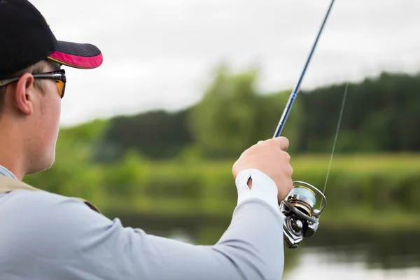 Fisherman with spinning closeup — Stock Photo, Image