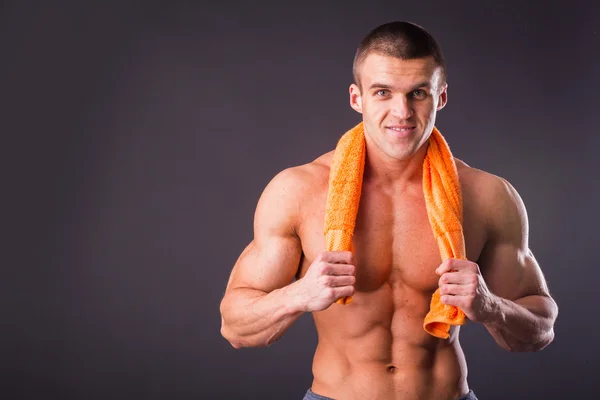 Man holding a orange towel — Stock Photo, Image