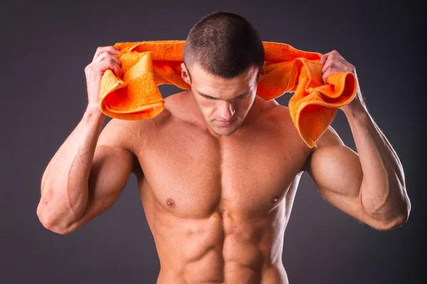 Man holding a orange towel — Stock Photo, Image