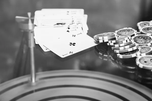 Poker chips and cards on a glass table — Stock Photo, Image