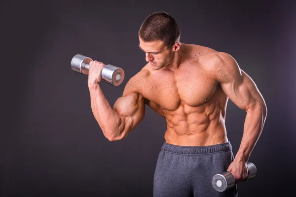 Deportista sosteniendo una mancuernas . — Foto de Stock