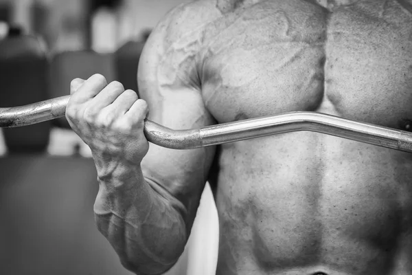 Man makes exercises with barbell. — Stock Photo, Image