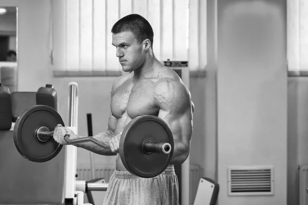 Man makes exercises with barbell. — Stock Photo, Image